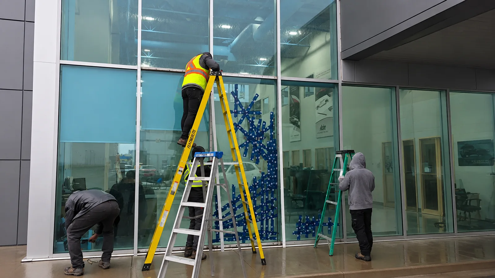 Glass Culture installers glazing a commercial storefront